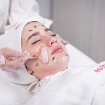 Pampering facial treatment using a roller for skin rejuvenation and relaxation.